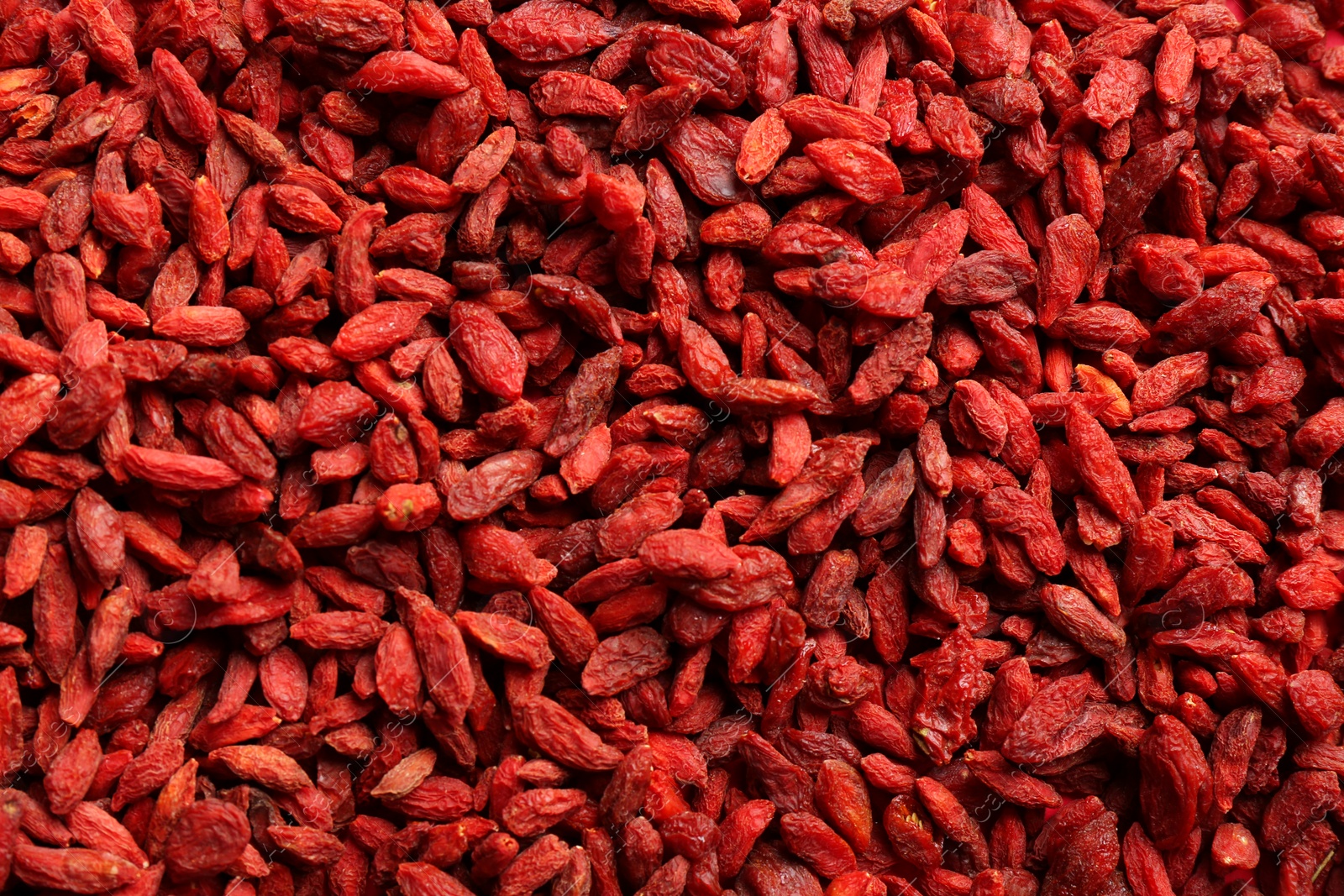 Photo of Many dried goji berries as background, top view. Healthy superfood