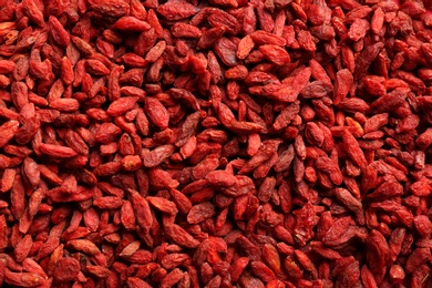 Photo of Many dried goji berries as background, top view. Healthy superfood