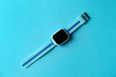 Photo of Trendy smart watch for kids on light blue background, top view