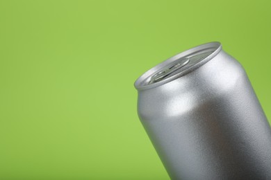 Photo of Can of energy drink on green background, closeup. Space for text