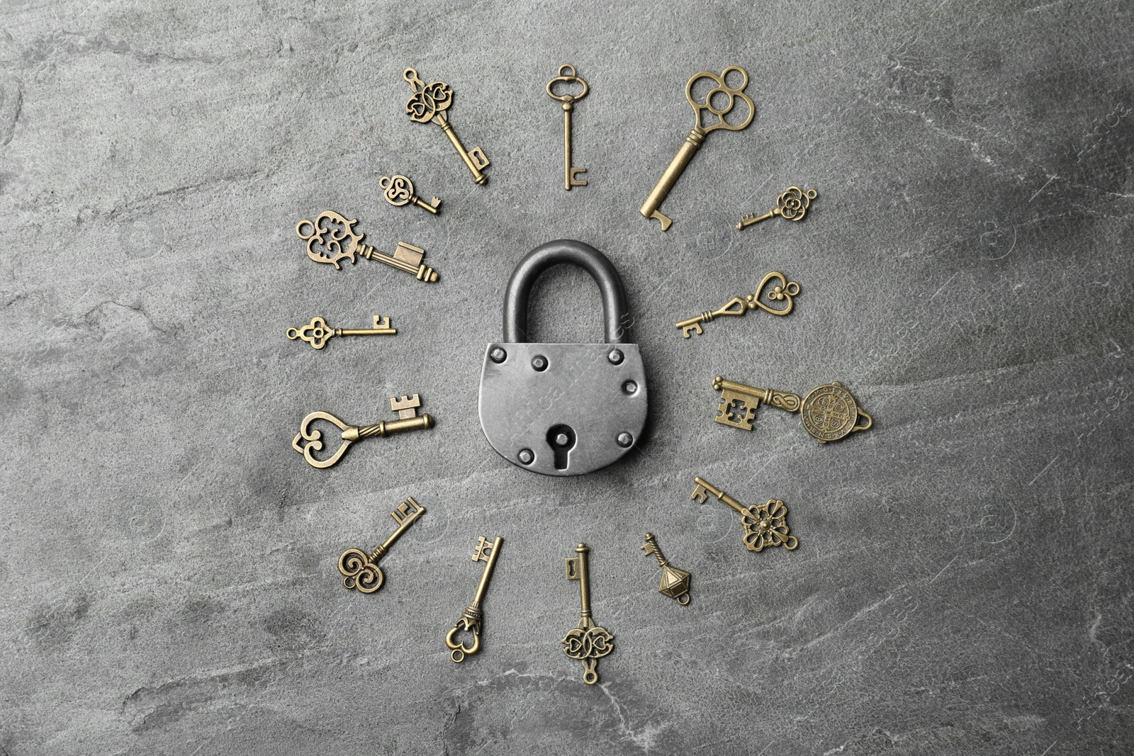 Photo of Steel padlock and keys on grey background, top view. Safety concept