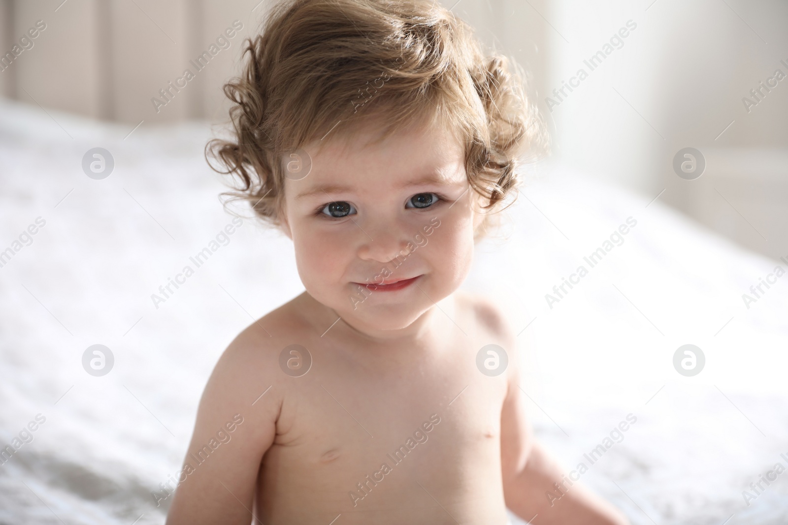 Photo of Cute little baby on bed at home