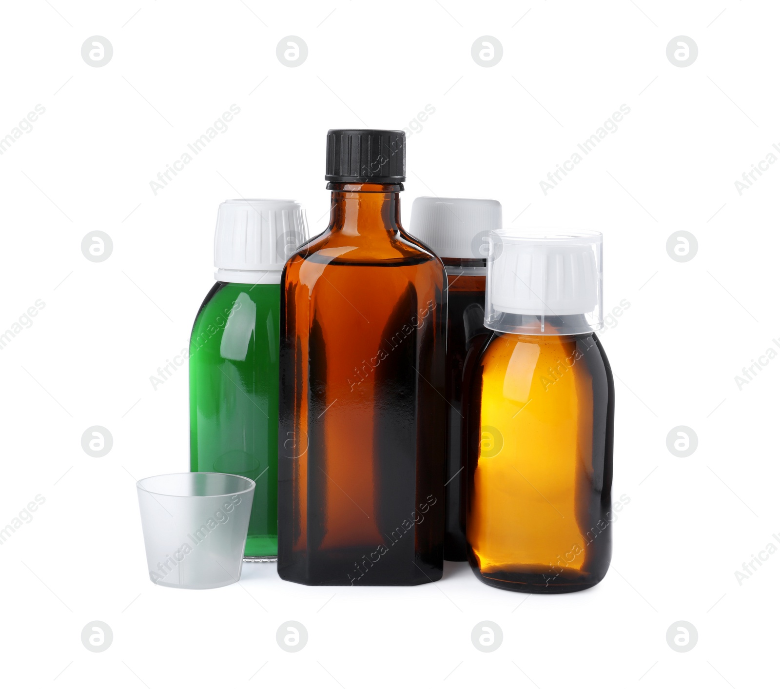 Photo of Bottles of syrups with measuring cups on white background. Cough and cold medicine