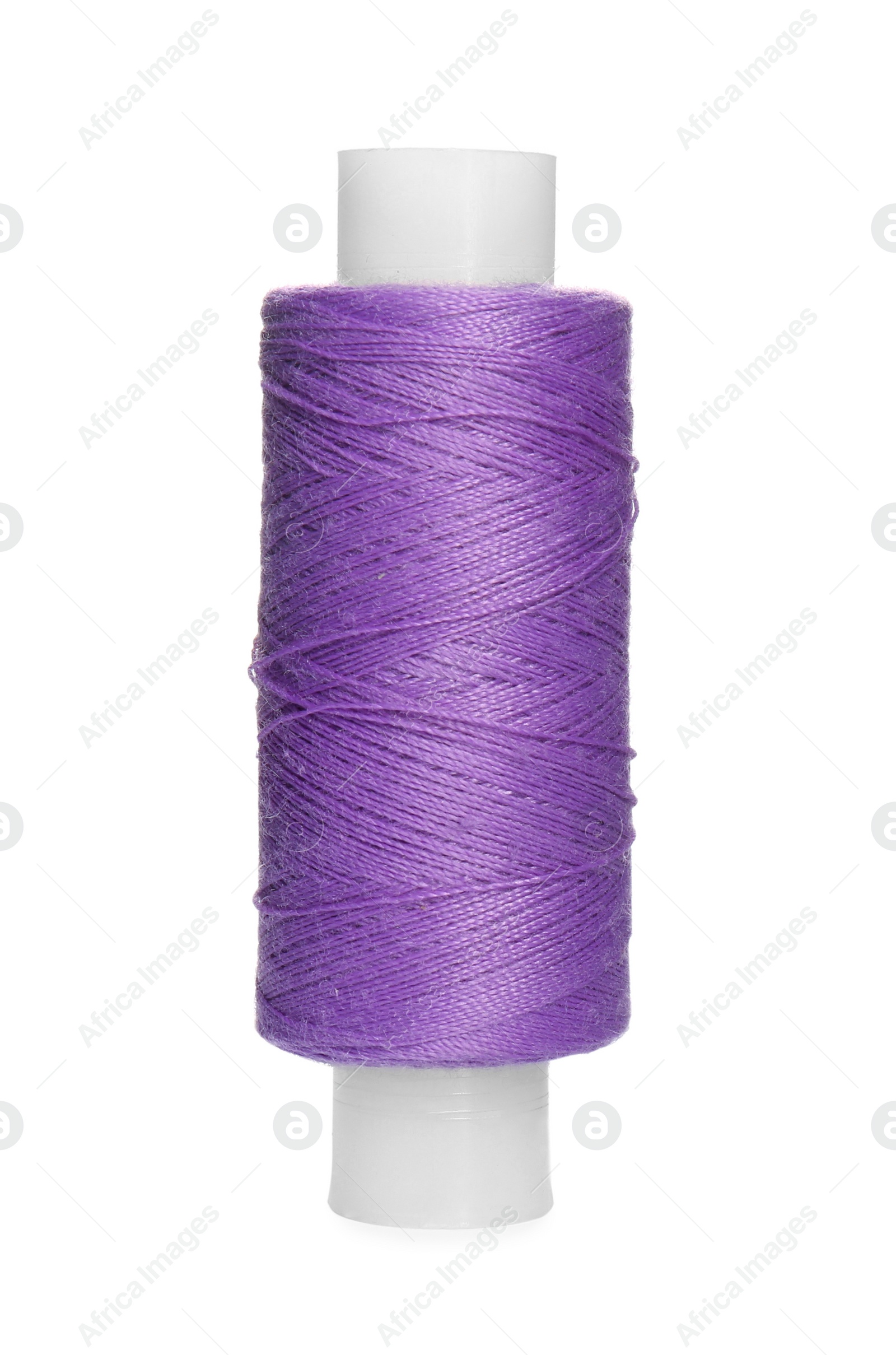 Photo of Spool of violet sewing thread isolated on white