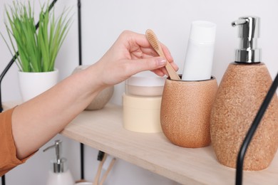 Photo of Bath accessories. Woman organizing personal care products indoors, closeup