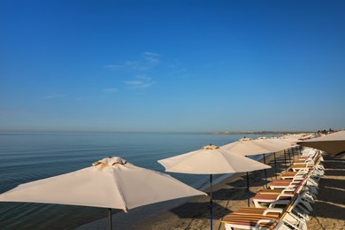 Photo of Many beach umbrellas and sunbeds at resort