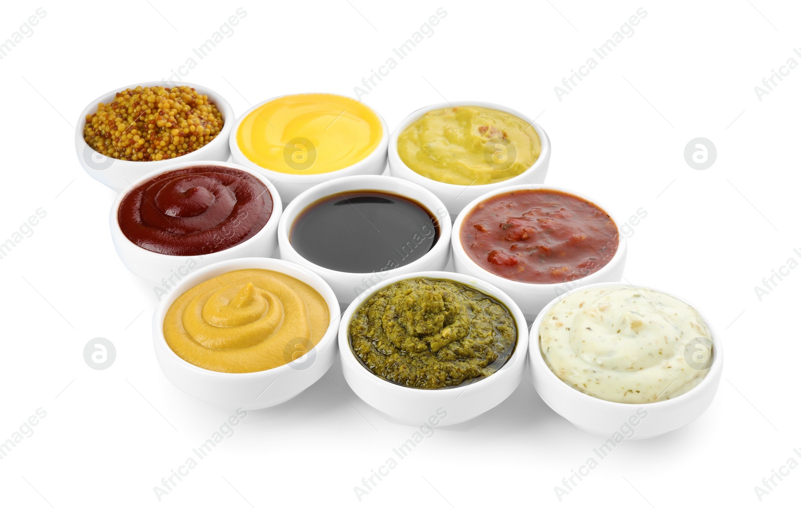 Photo of Many different sauces in bowls on white background