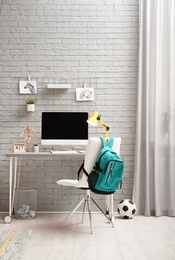 Photo of Comfortable workplace with modern computer in child room