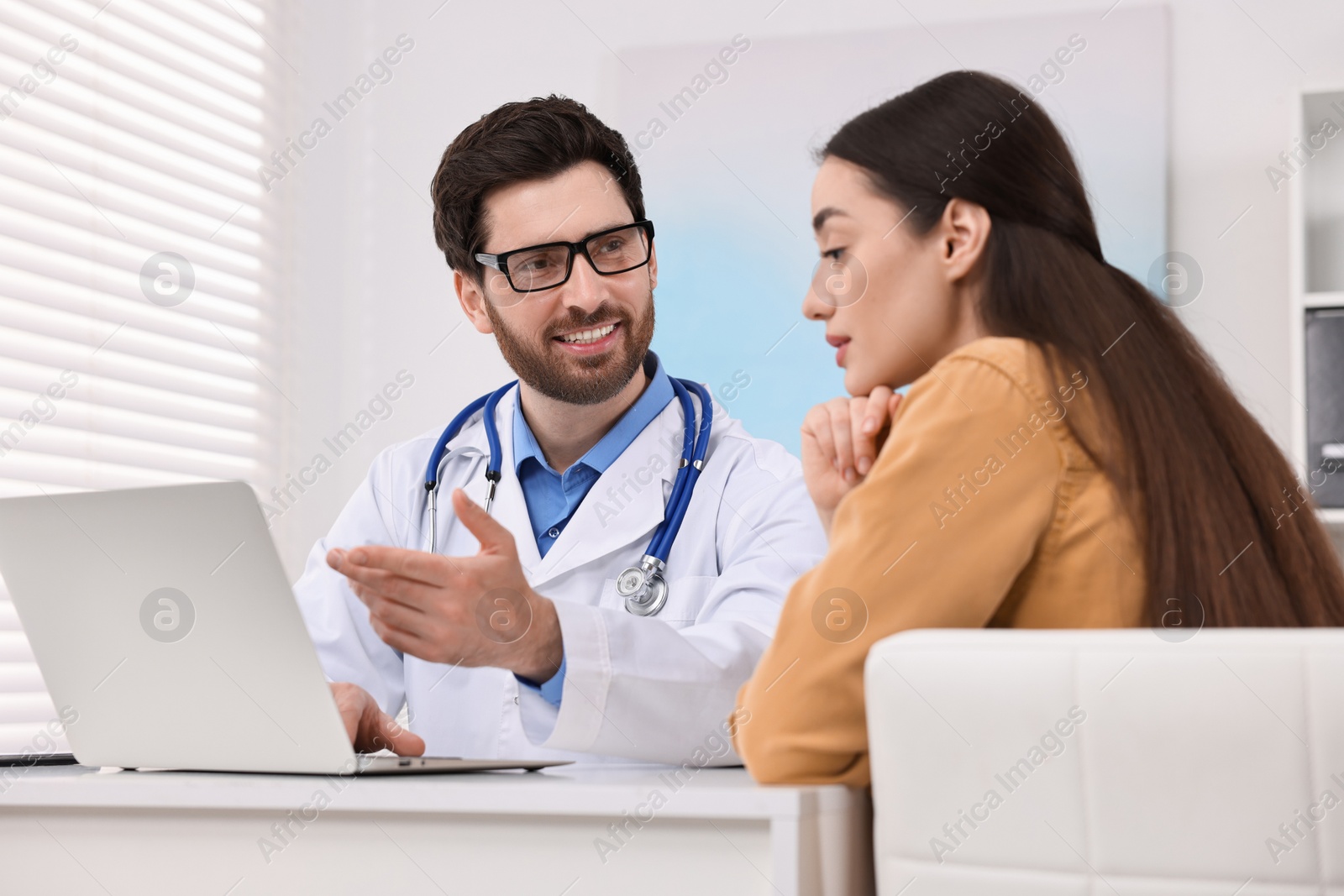 Photo of Doctor consulting patient during appointment in clinic