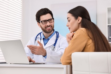 Photo of Doctor consulting patient during appointment in clinic