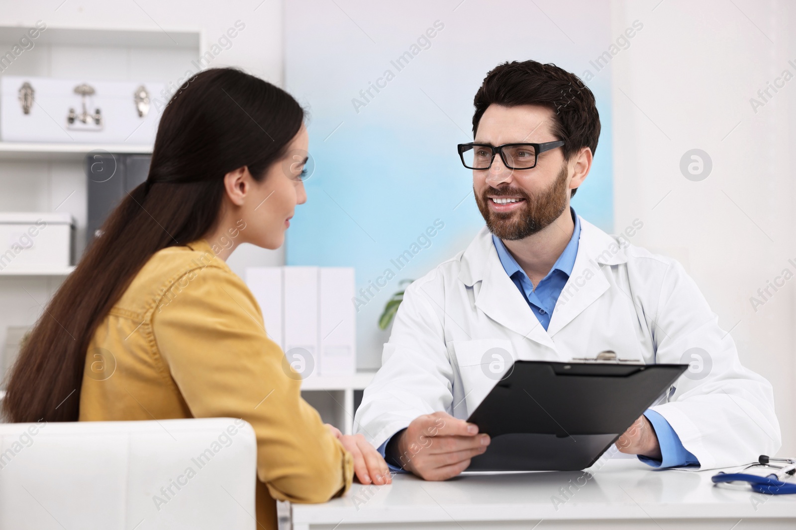 Photo of Doctor consulting patient during appointment in clinic