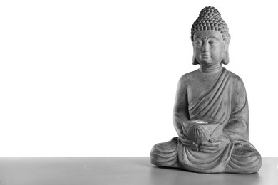 Photo of Beautiful stone Buddha sculpture on table against grey background. Space for text