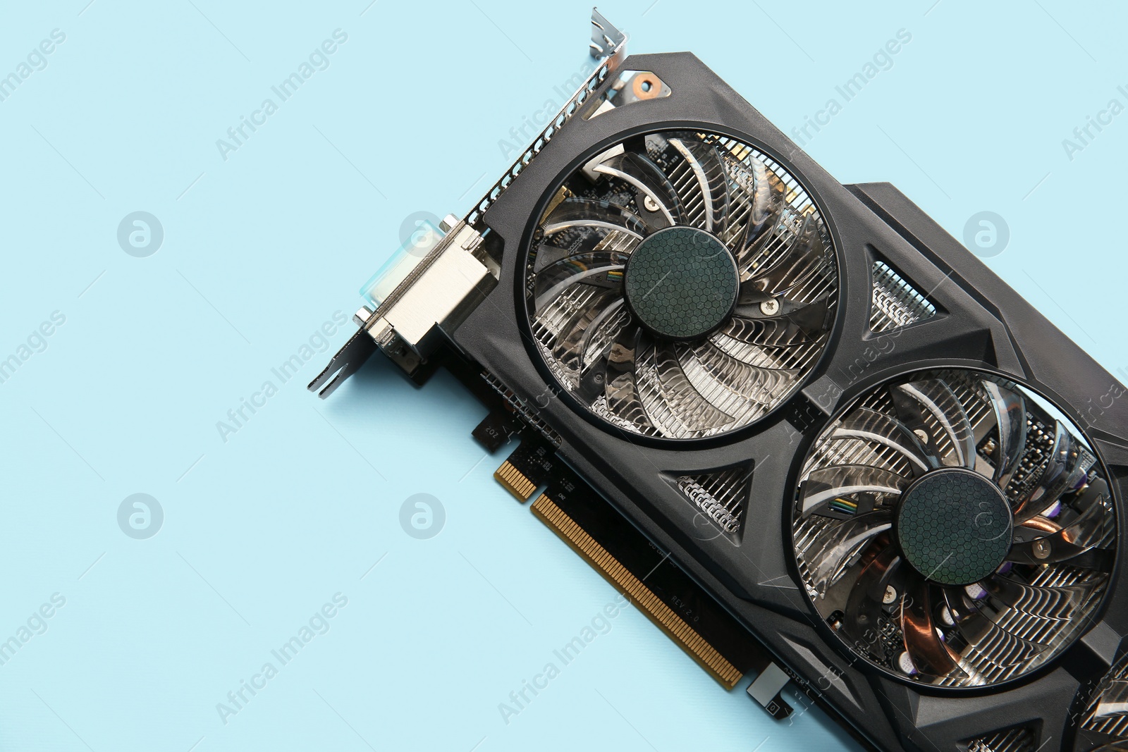 Photo of One graphics card on light blue background, top view. Space for text