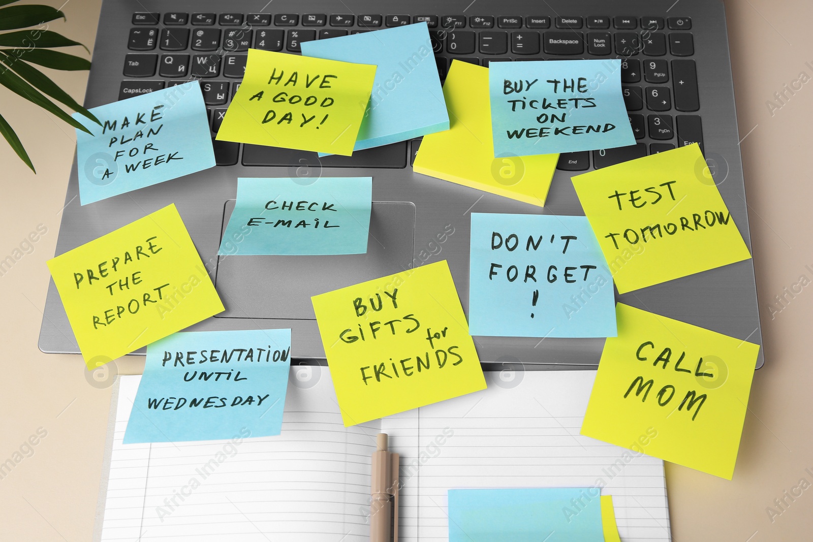 Photo of Different reminder notes and laptop on white table