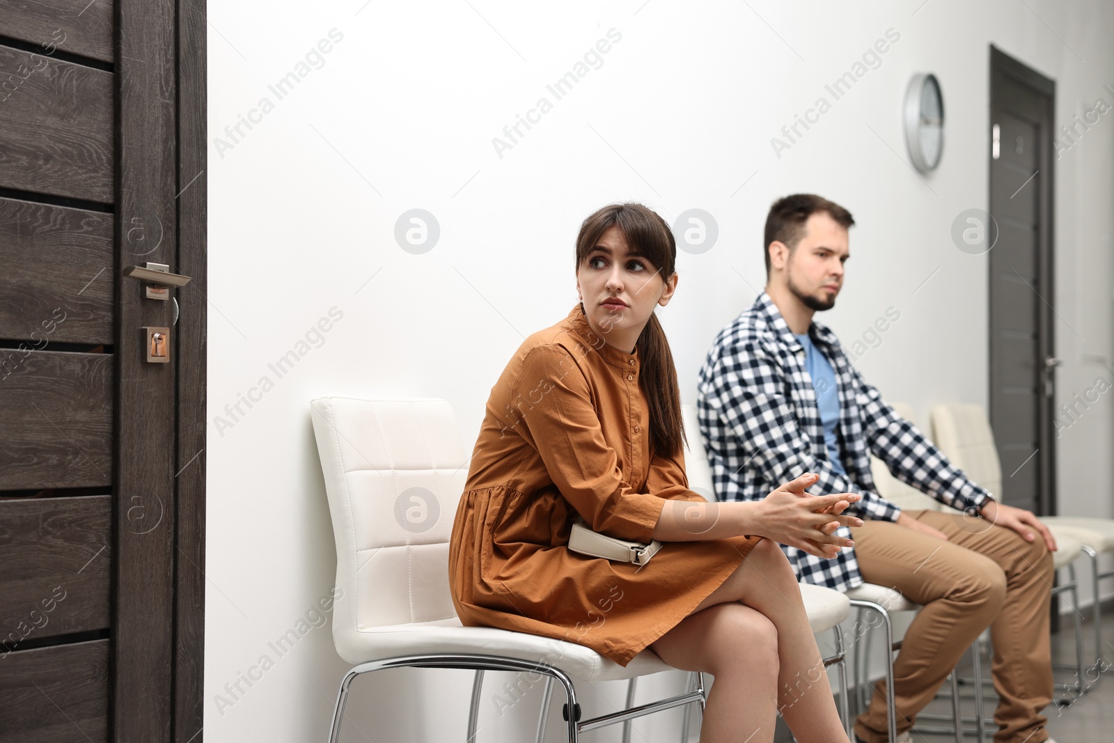 Photo of Woman and man waiting for appointment indoors