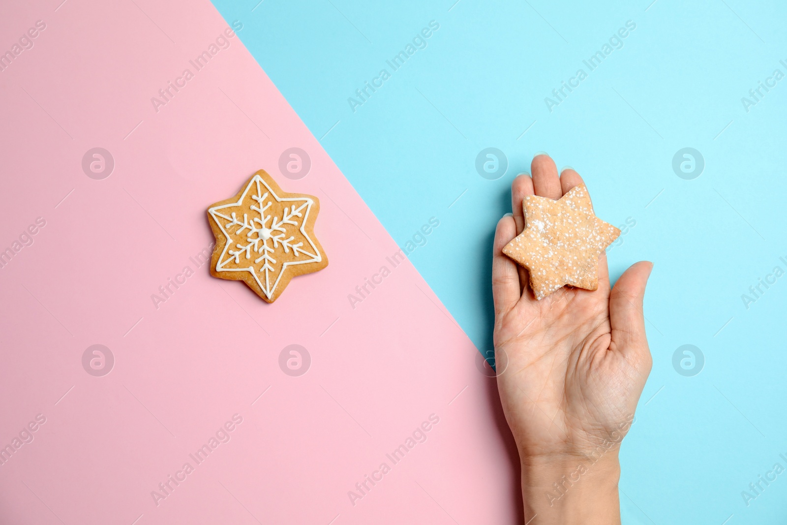 Photo of Woman holding tasty homemade Christmas cookie on color background