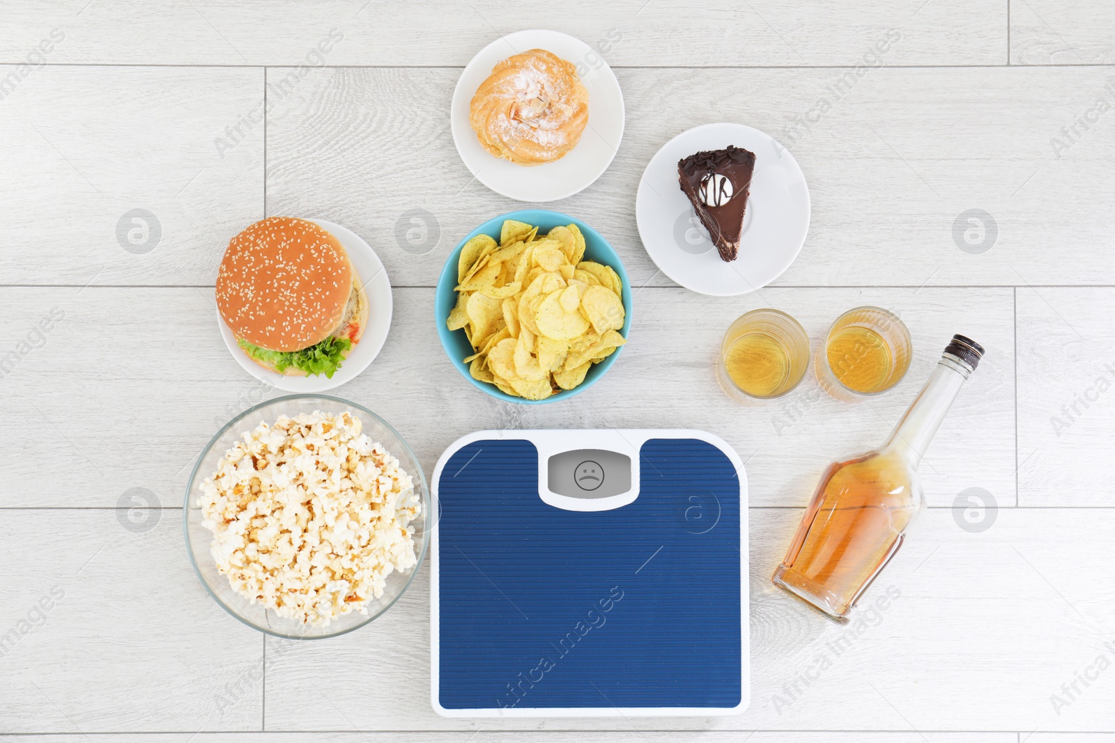 Photo of Flat lay composition with scales, different food and alcohol on floor. After party chaos