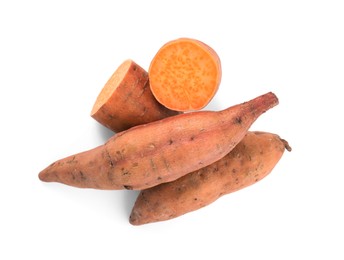 Whole and cut ripe sweet potatoes on white background, top view