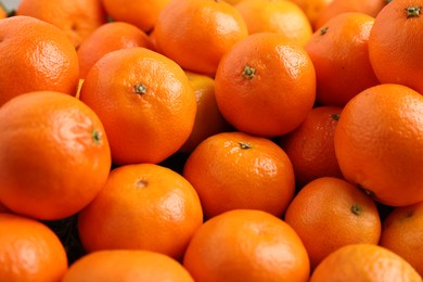 Delicious fresh tangerines as background, closeup view