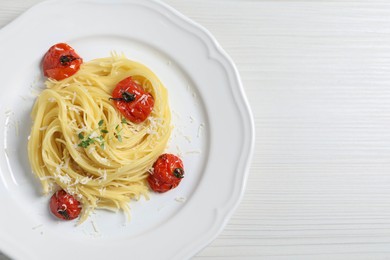 Photo of Tasty capellini with tomatoes and cheese on white wooden table, top view and space for text. Exquisite presentation of pasta dish