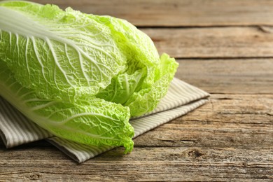 Fresh ripe Chinese cabbage on wooden table, closeup. Space for text