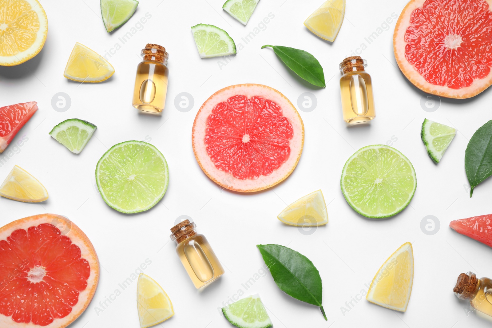 Photo of Flat lay composition with bottles of citrus essential oil on white background