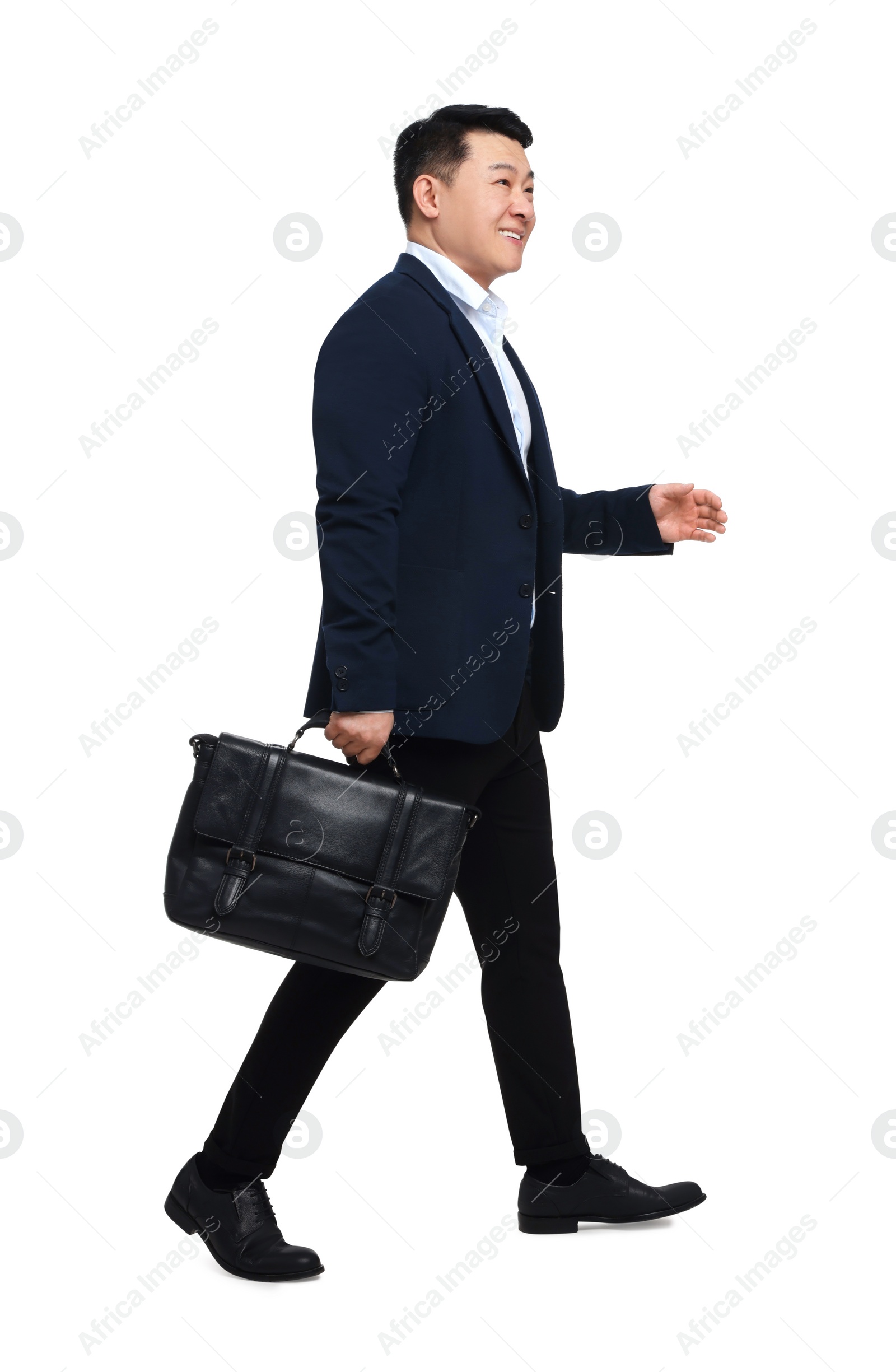 Photo of Businessman in suit with briefcase walking on white background