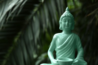 Photo of Decorative Buddha statue outdoors, closeup. Space for text