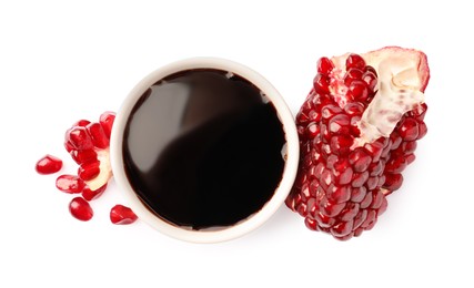 Photo of Bowl of pomegranate sauce and fresh ripe fruit on white background