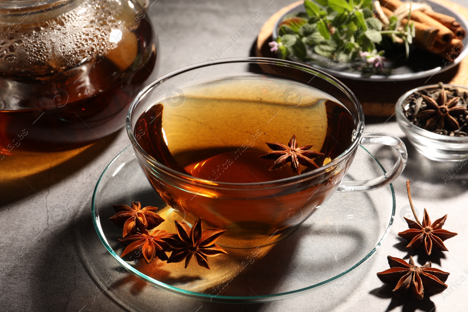 Photo of Aromatic tea with anise stars on light grey table