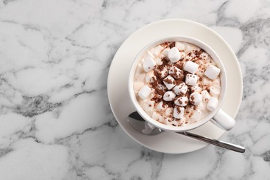 Photo of Cup of aromatic hot chocolate with marshmallows and cocoa powder served on white marble table, top view. Space for text