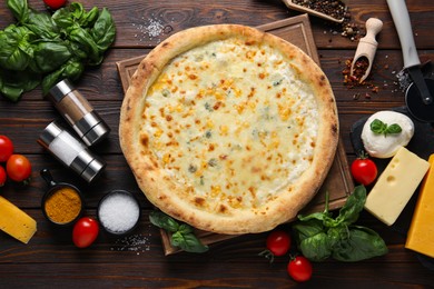 Flat lay composition with delicious cheese pizza and ingredients on wooden table