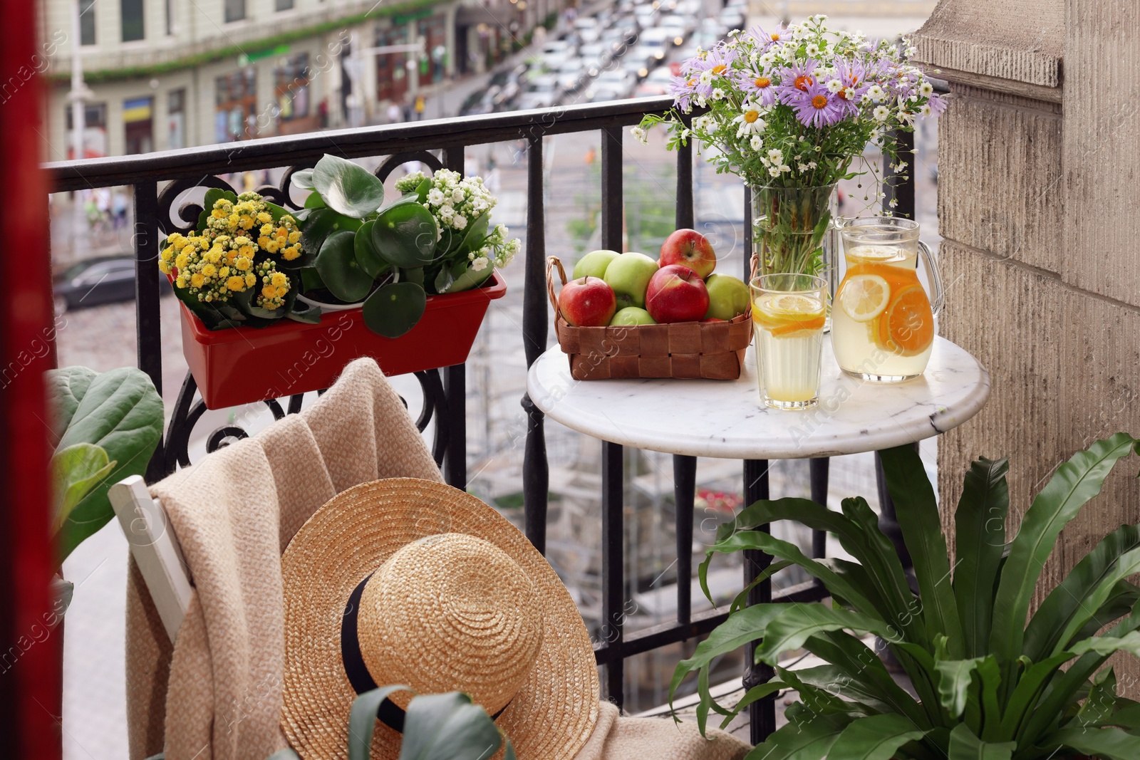 Photo of Relaxing atmosphere. Stylish furniture surrounded by beautiful houseplants on balcony