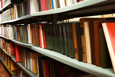 Collection of different books on shelves in library