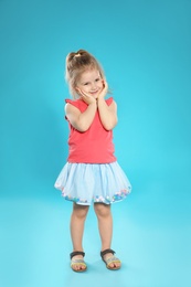 Photo of Full length portrait of cute little girl against color background
