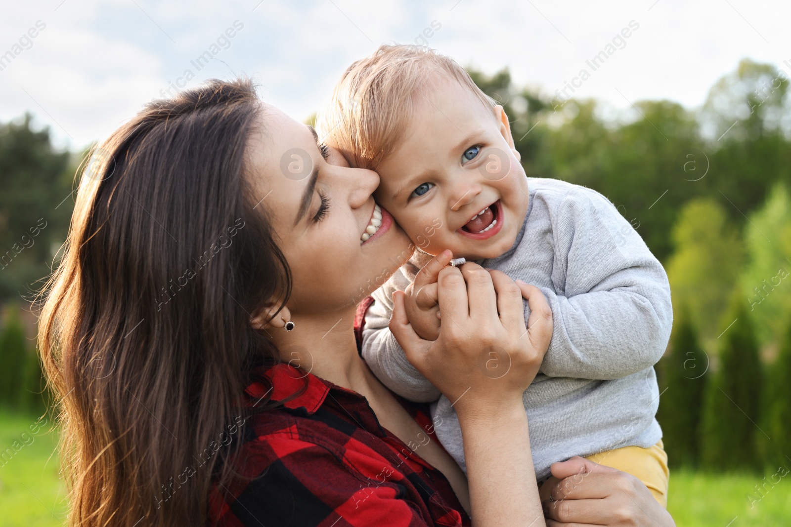 Photo of Happy mother with her cute baby in park on sunny day