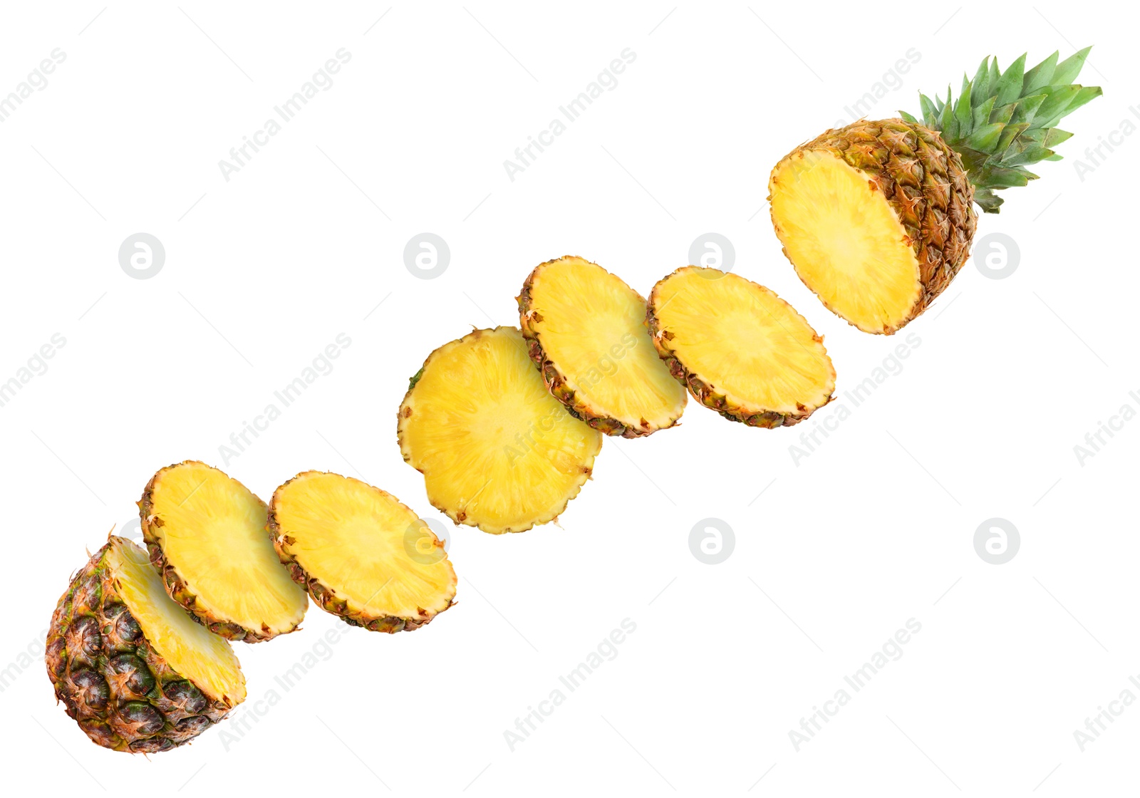 Image of Slices of juicy pineapple flying between its top and bottom on white background