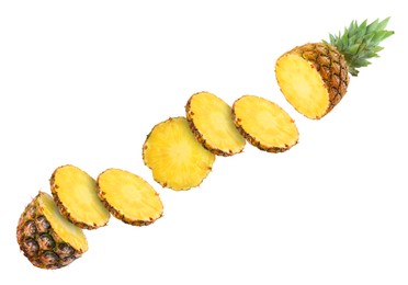 Image of Slices of juicy pineapple flying between its top and bottom on white background