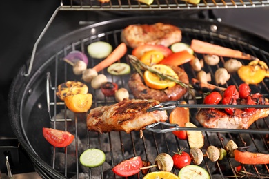 Cooking delicious meat and vegetables on barbecue grill, closeup