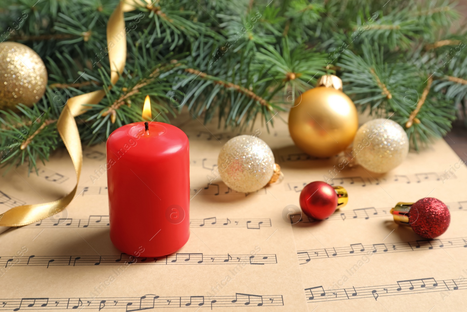 Photo of Composition with Christmas decorations and music sheets on table