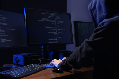 Photo of Hacker with computers in dark room. Cyber crime