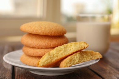 Photo of Delicious Danish butter cookies on wooden table, closeup