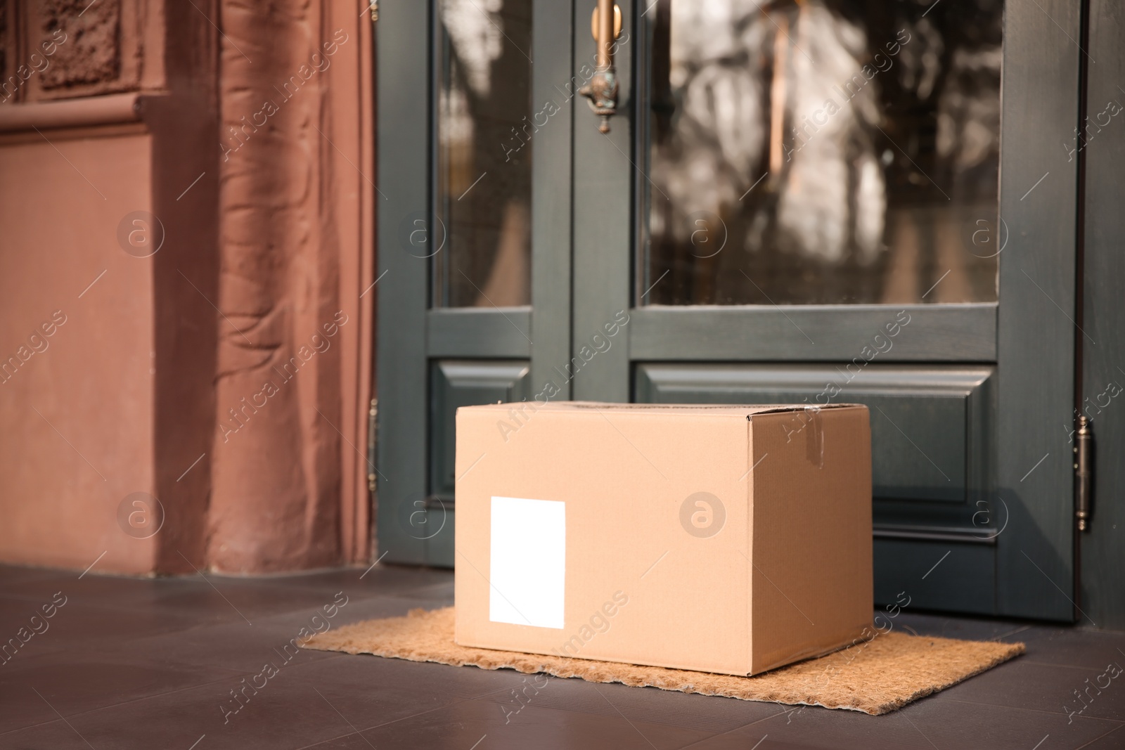 Photo of Delivered parcel on door mat near entrance