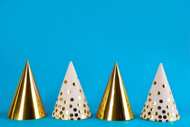 Colorful party hats on light blue background