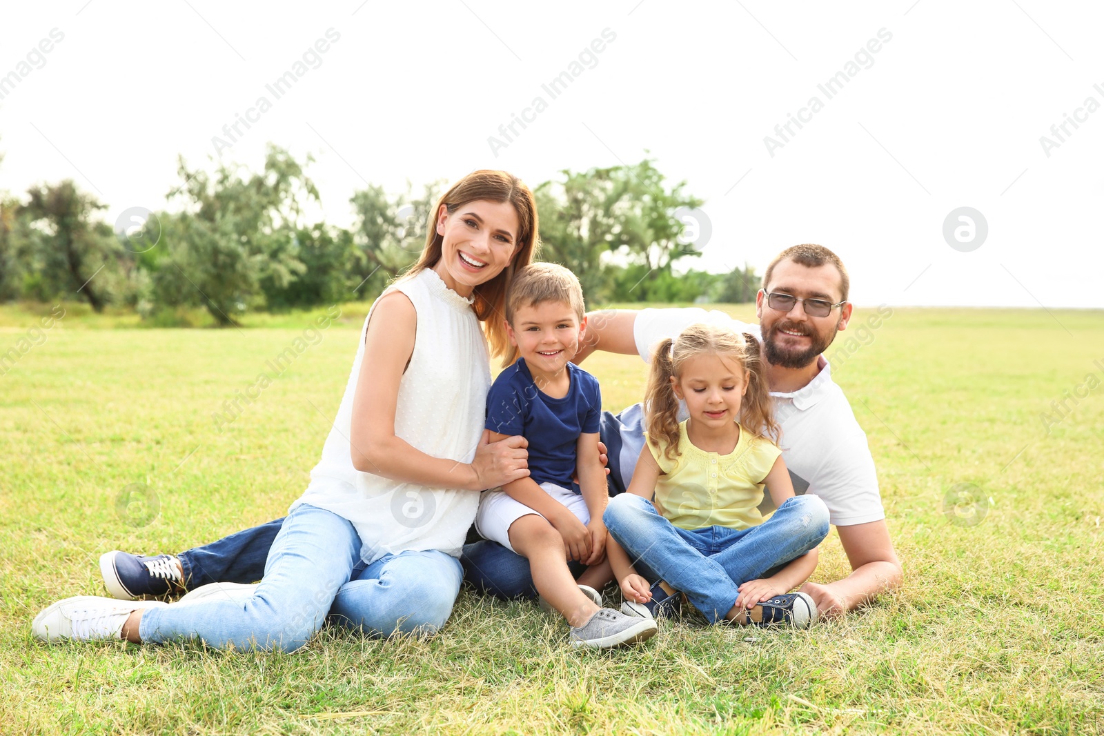 Photo of Happy family spending time together with their children outdoors