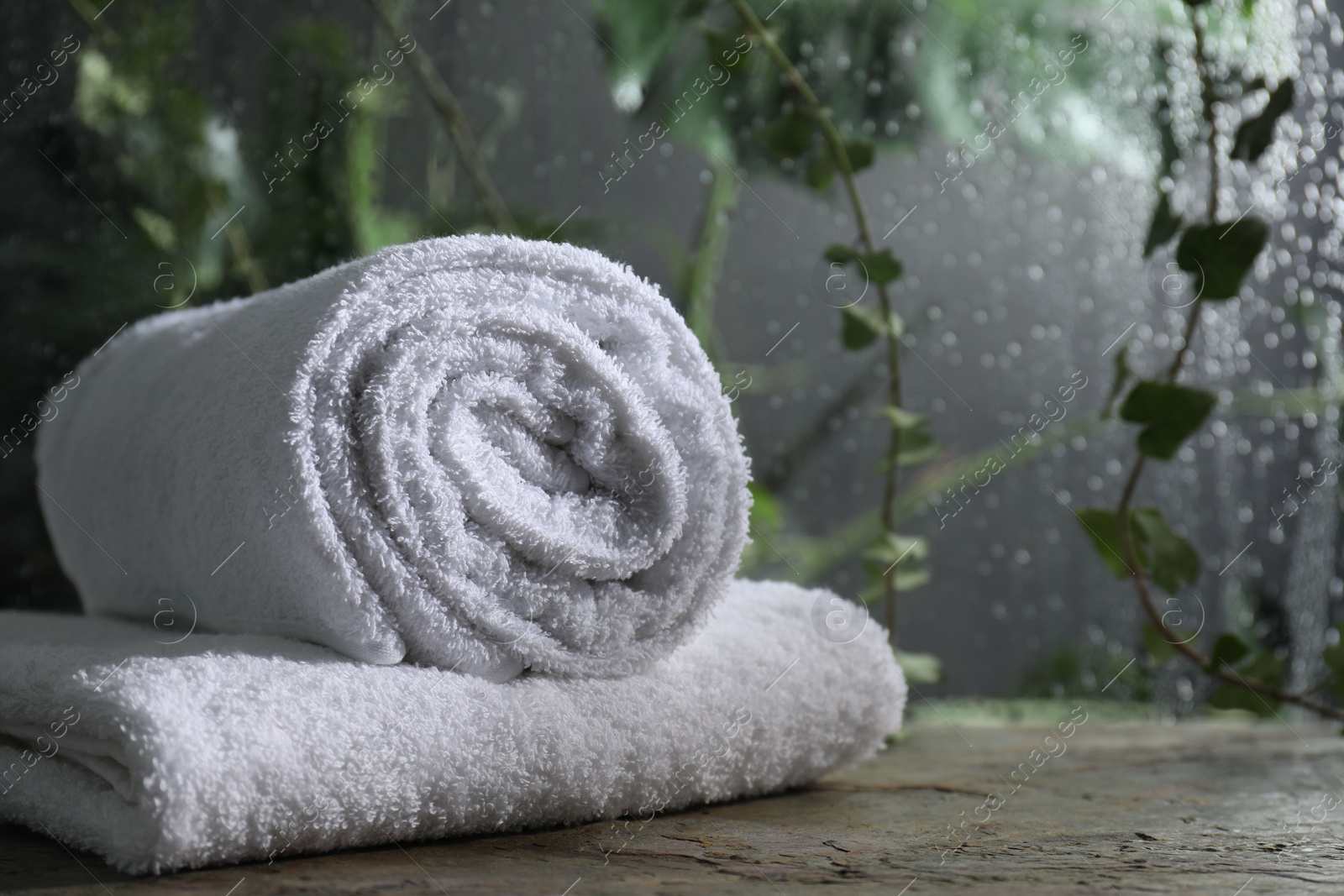 Photo of White terry towels on table in bathroom, space for text