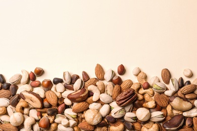 Photo of Flat lay composition with organic mixed nuts and space for text on color background