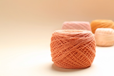Photo of Clew of knitting threads on color background, space for text. Sewing stuff