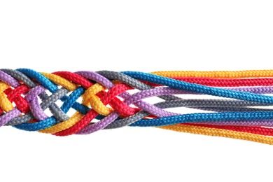 Photo of Braided colorful ropes on white background. Unity concept