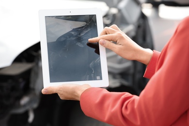 Photo of Woman photographing broken car after accident for insurance claim, closeup